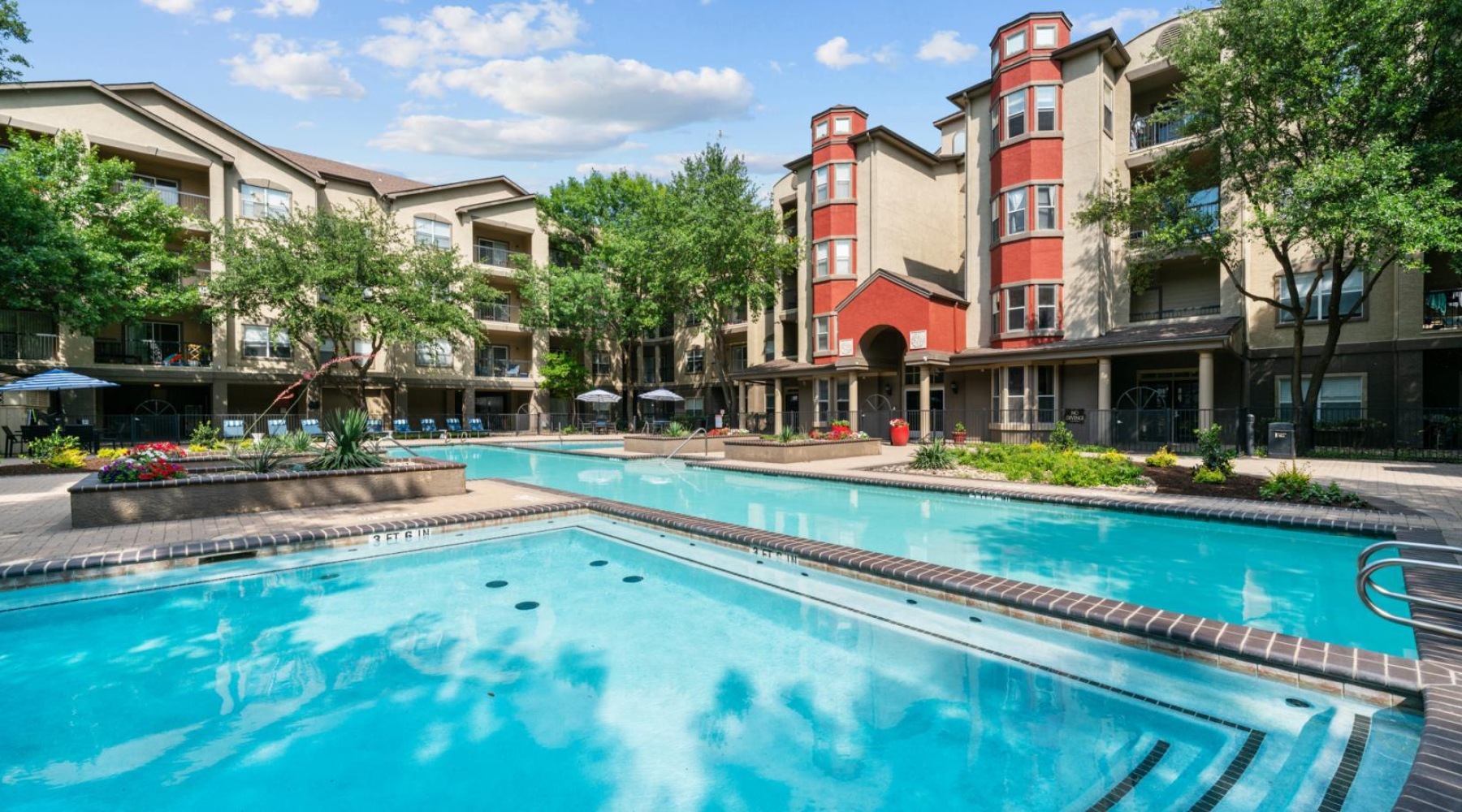 a swimming pool in front of a row of buildings