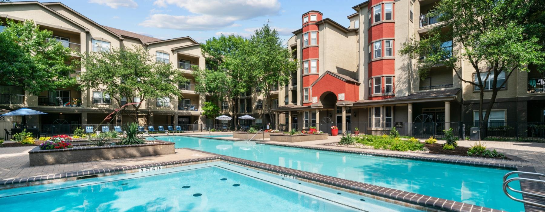a swimming pool in front of a row of buildings