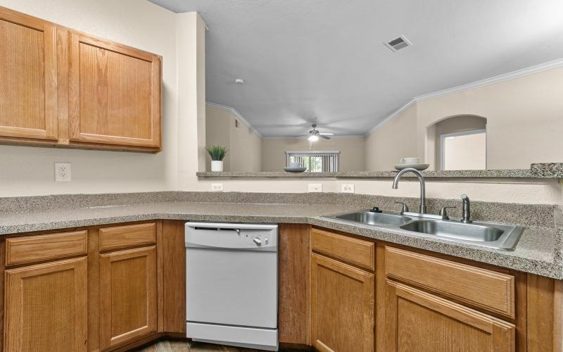 a kitchen with wooden cabinets and granite countertops