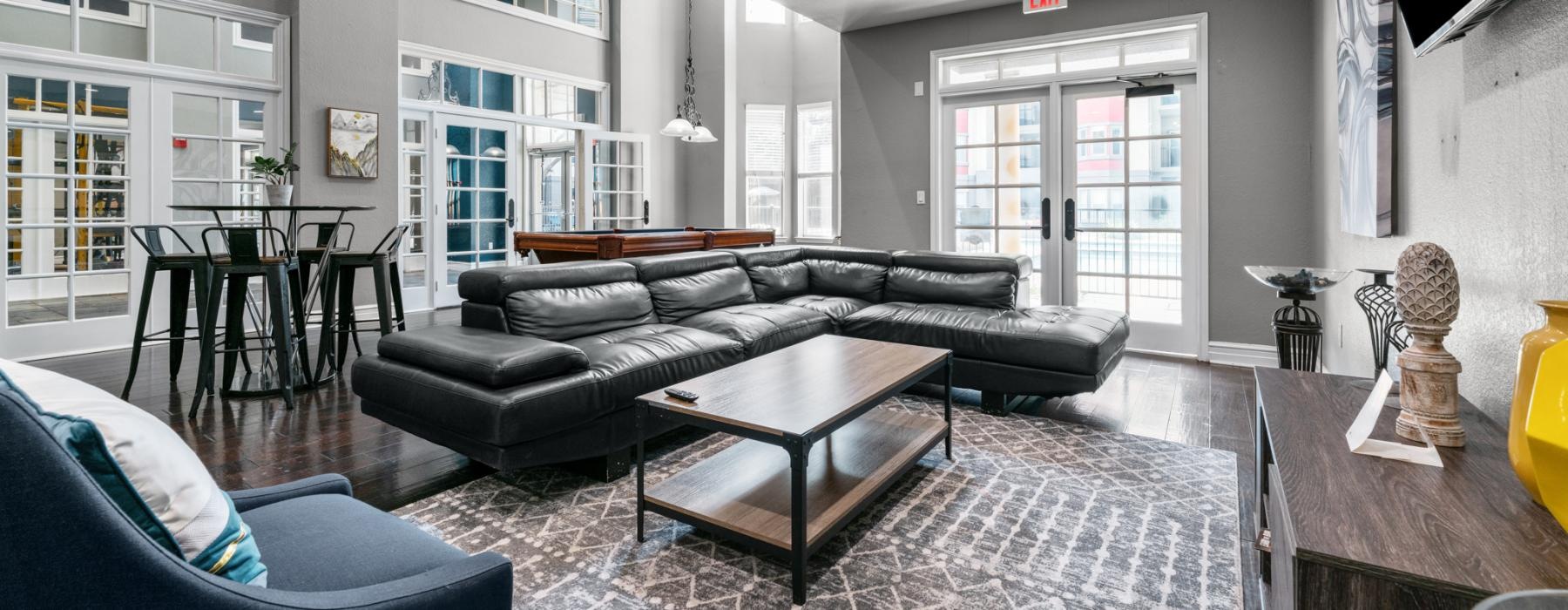 a lounge room with a couch and a table and chairs