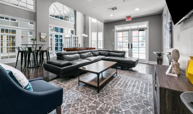 a lounge room with a couch and a table and chairs
