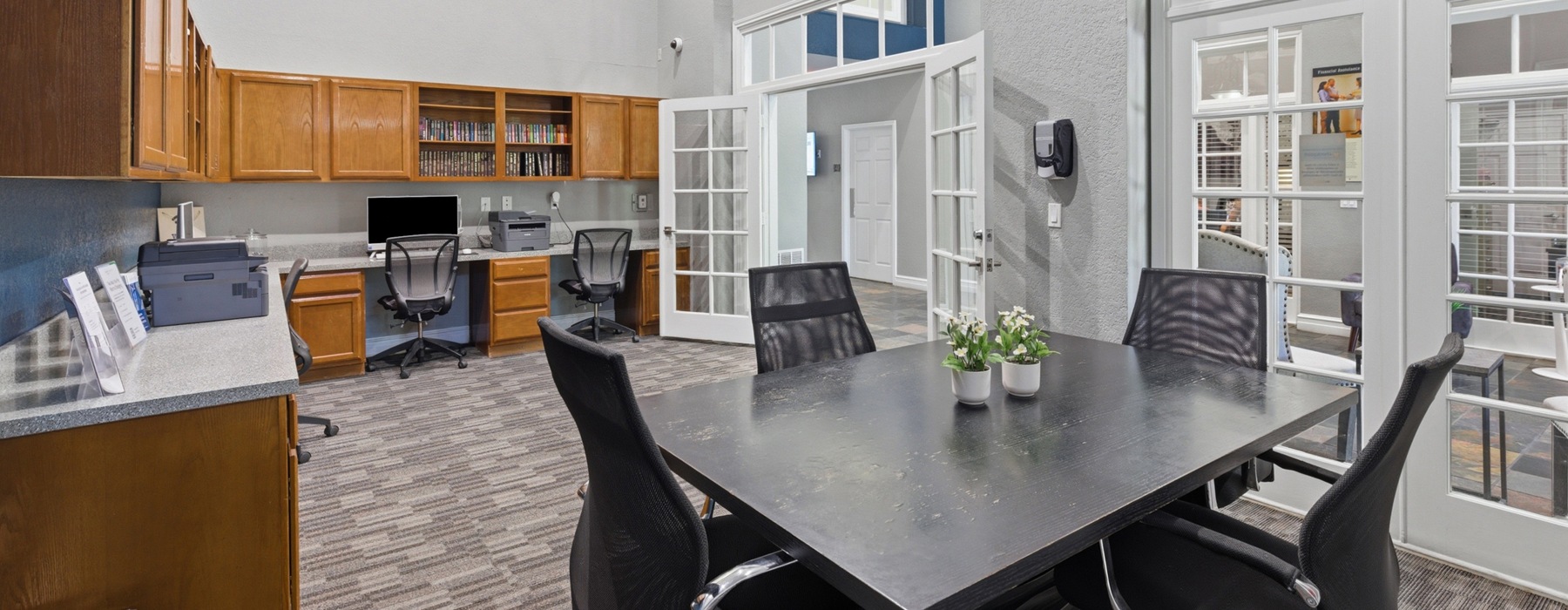 office with a large desk and a table with four chairs